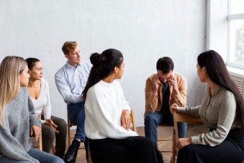 A photo of a group looking at someone who’s talking | Image by freepik