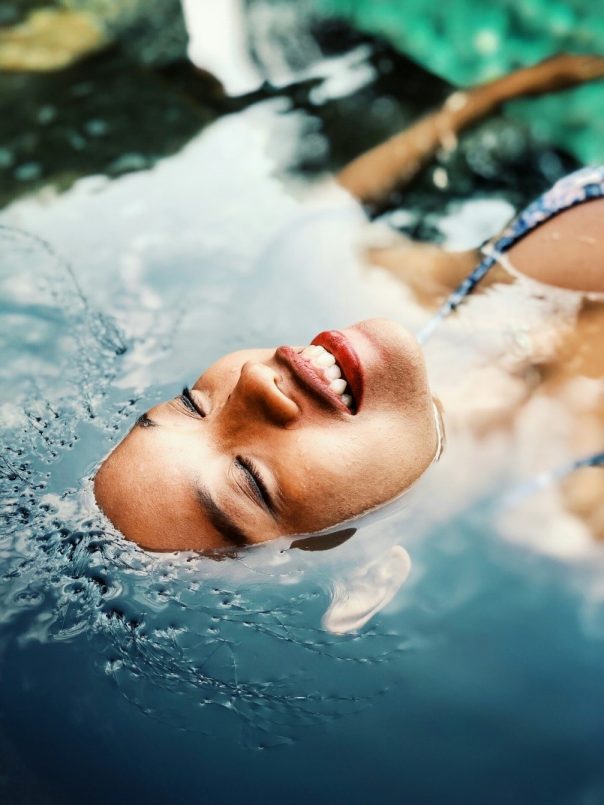 A woman drifting in the water, partially submerged