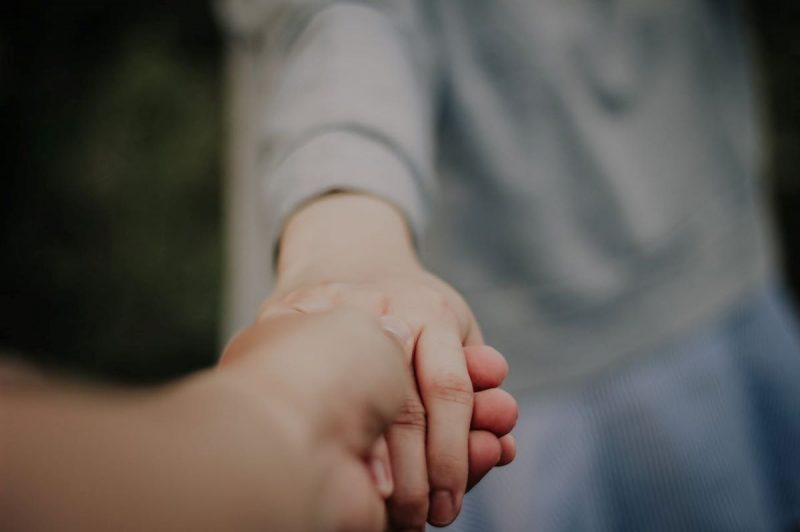 someone holding the other person’s hand
